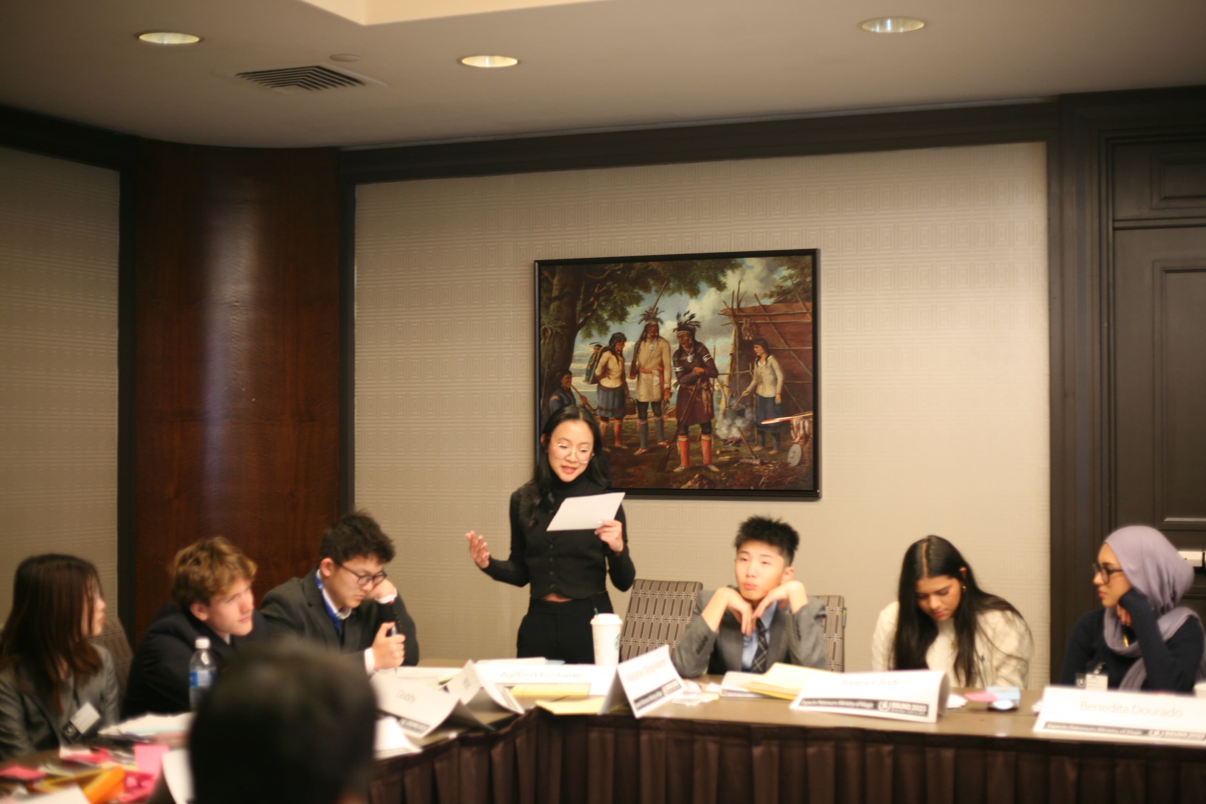 Delegates caucusing during a crisis simulation